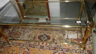 A brass and glass coffee table