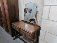 A two drawer carved oak dressing table