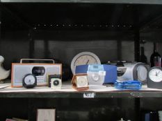 A shelf of clocks, clock radios etc