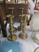2 pairs of polished brass candlesticks