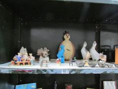 A shelf of assorted animal figures etc