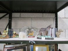 A shelf of miscellaneous items including book ends,