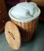 A wicker linen bin and contents