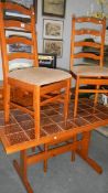 A tiled top kitchen table and 3 chairs