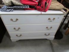 A white three drawer chest
