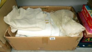 A box of linen, lace, table cloths etc