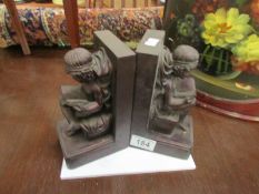 A pair of figural book ends