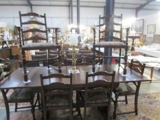 An oak extending dining table and a set of 6 ladder back chairs 1 A/F & 2 carvers