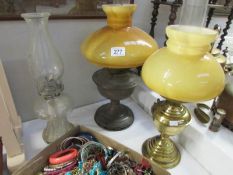 2 brass oil lamps and one other