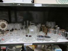 A shelf of assorted glass ware