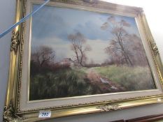 A gilt framed oil on canvas rural scene