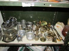 A shelf of assorted metal ware