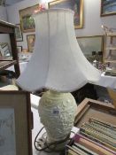 A ceramic table lamp with shade