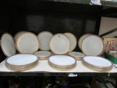 A Shelf of Cauldon gold rimmed plates,