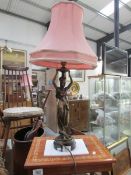 A figural table lamp with shade