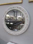 A circular painted mirror