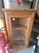 A pine glazed corner cupboard