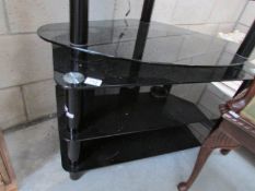 A black glass TV table