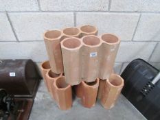 A quantity of terracotta garden tubes