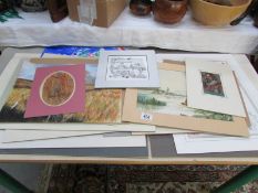 A large collection of unframed paintings and prints