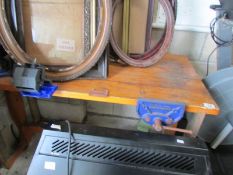 A work bench with attached vices