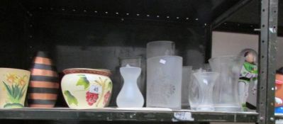 A shelf of ceramic and glass vases