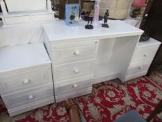 A modern white dressing table with matching pair of bedsides