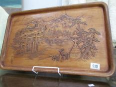 An oriental carved tray