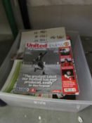 A box of Manchester United programmes,