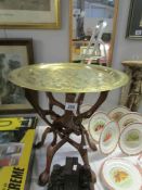 An Arabic table with brass tray top