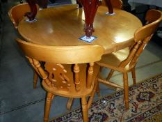 A pine round table & 4 chairs