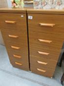 A pair of 5 drawer teak chests
