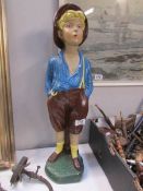 A plaster figure of a whistling boy