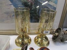 A pair of candlelamps with glass shades