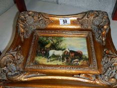 A gilded framed picture of horses