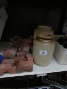 2 stoneware jars and a quantity of terracotta pot raisers