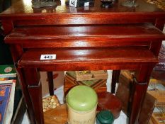 A nest of 3 mahogany tables