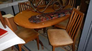 A teak table and 6 chairs