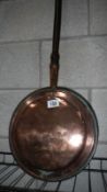 A Victorian copper warming pan