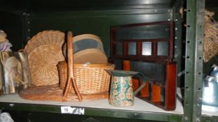 A shelf of wicker ware and wooden trays