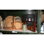 A shelf of wicker ware and wooden trays