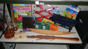 A shelf of miscellaneous including wooden crocodile, wooden items,