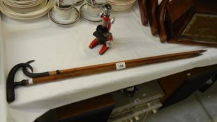 2 walking sticks with horn handles and writing to stick