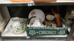 A shelf of pottery including Poole and Royal Doulton