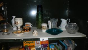 A shelf of pottery and glass