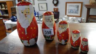 A wooden Father Christmas Russian doll set