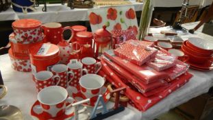 A large quantity of new red and white kitchenware