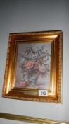 A picture of flowers in gilt frame