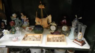 A shelf of miscellaneous including Ivorex plaques of Lincoln, figurines, clocks,