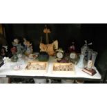 A shelf of miscellaneous including Ivorex plaques of Lincoln, figurines, clocks,